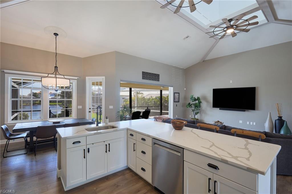 Great room with vaulted ceilings and lake view through the lanai
